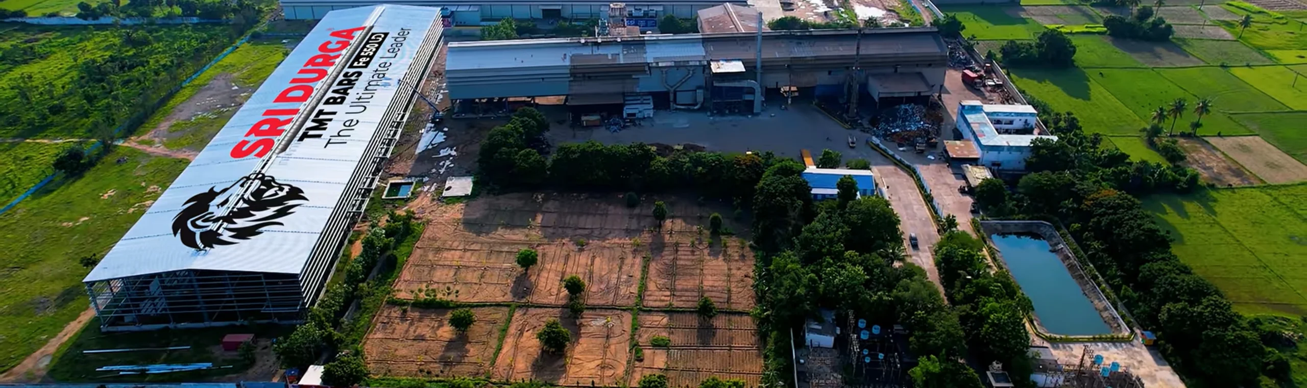 Industrial worker wearing safety gear inspecting metal or steel materials in factory